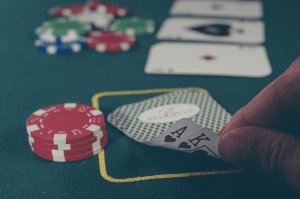 A poker player’s cards along with his chips, the pot, and the flopped cards