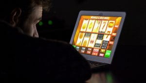 UK User Watching an Online Slot Machine on a Laptop