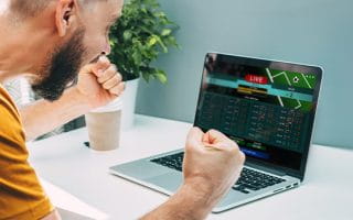 A man staring at a sportsbook on his computer