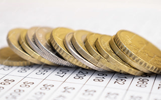 A picture of a betting ticket with coins on top of it