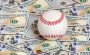 A baseball on top of USD banknotes