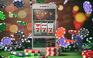 A smartphone displaying a slot machine with '777' symbols, surrounded by falling poker chips in various colors.