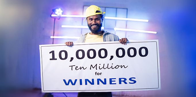 An image of a jackpot winner with a large cheque