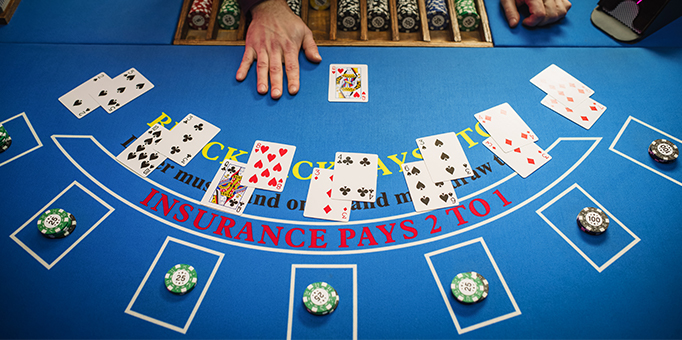 An image of cards being dealt during a blackjack game