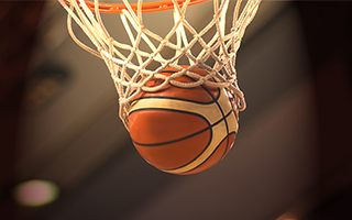 A basketball falling in the net